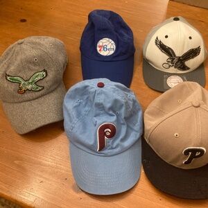 Five Philadelphia sports hats.